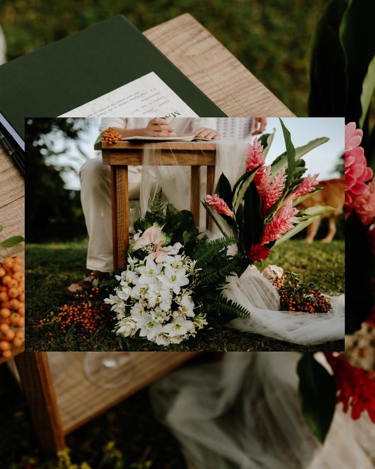 Signing the marriage register at a wooden table, with white tiare and pink ginger flowers on the grass